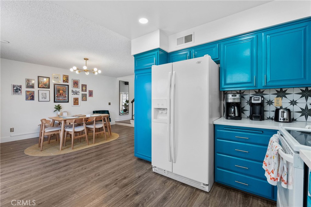 6134 Arroyo Road, Unit 3 Palm Springs, CA 92264 - Photo 9 of 35 a kitchen with granite countertop appliances cabinets and wooden floor