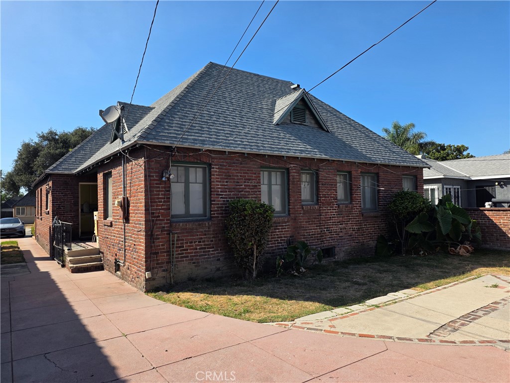 320 South Sloan Avenue Compton, CA 90221 - Photo 3 of 4 a backyard of a house with yard fire pit barbeque oven and outdoor seating