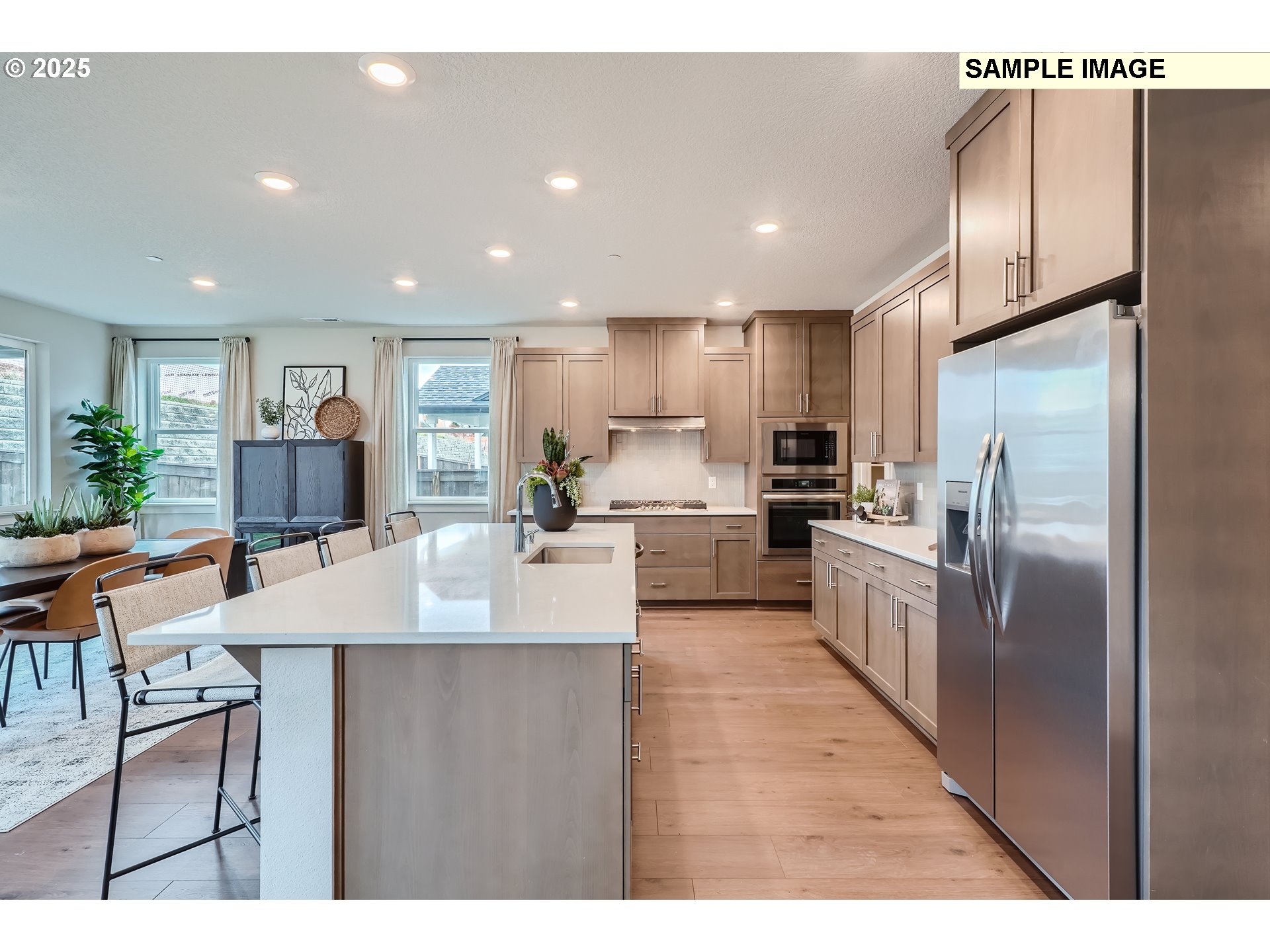 2636 South 4th Way Ridgefield, WA 98642 - Photo 7 of 34 a large kitchen with stainless steel appliances lots of counter space and a refrigerator
