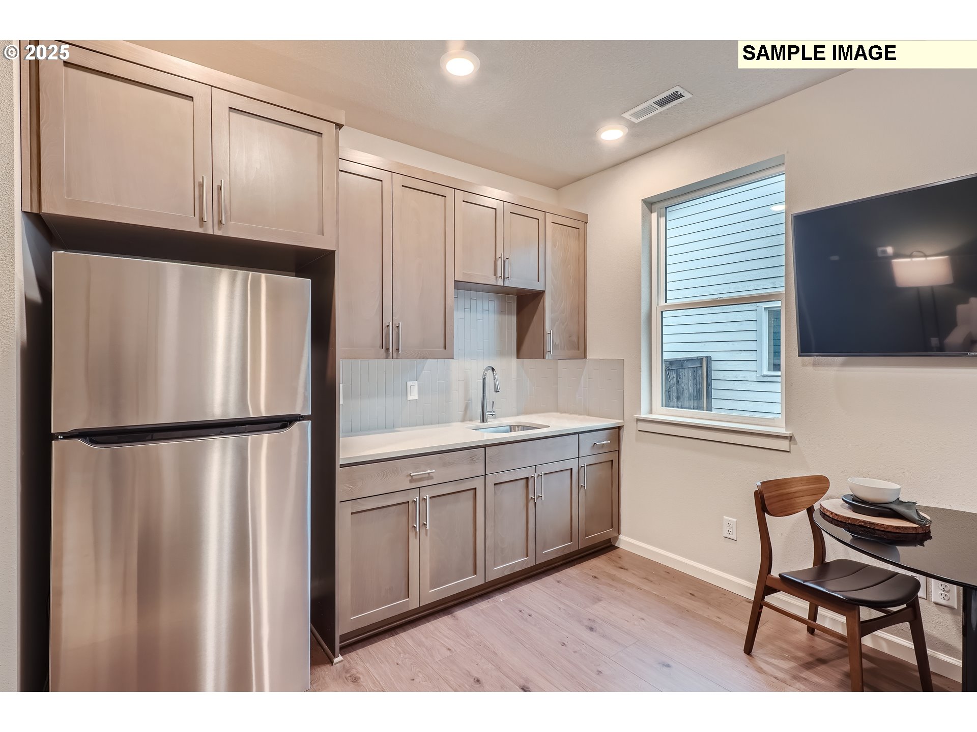 2636 South 4th Way Ridgefield, WA 98642 - Photo 10 of 34 a kitchen with stainless steel appliances a refrigerator sink and wooden floor