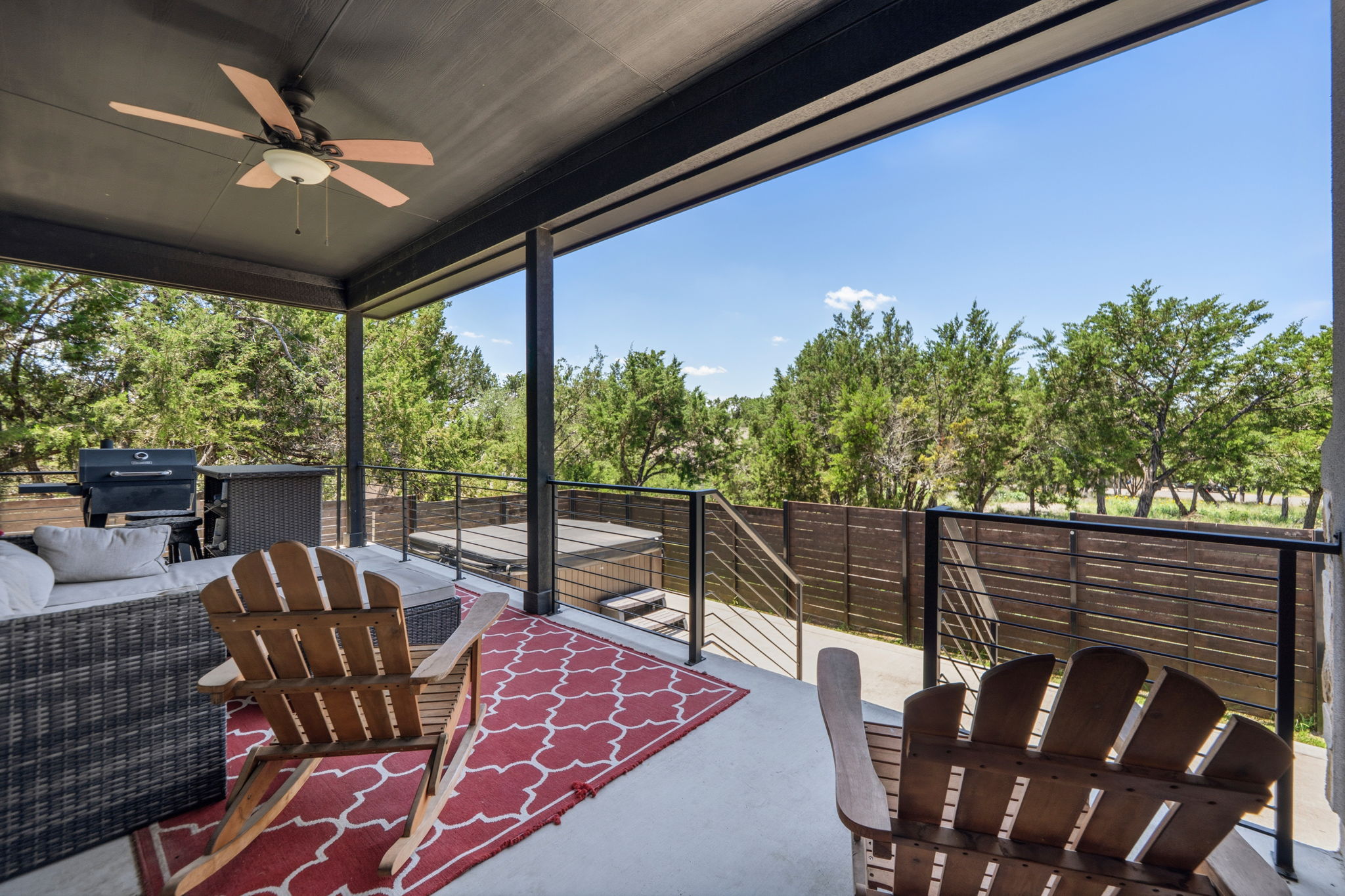 18605 Masters Cove Point Venture, TX 78645 - Photo 27 of 40 Covered outdoor patio featuring a ceiling fan, concrete flooring, and a contemporary black metal railing system