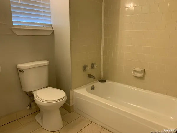 a bathroom with a toilet and a bathtub