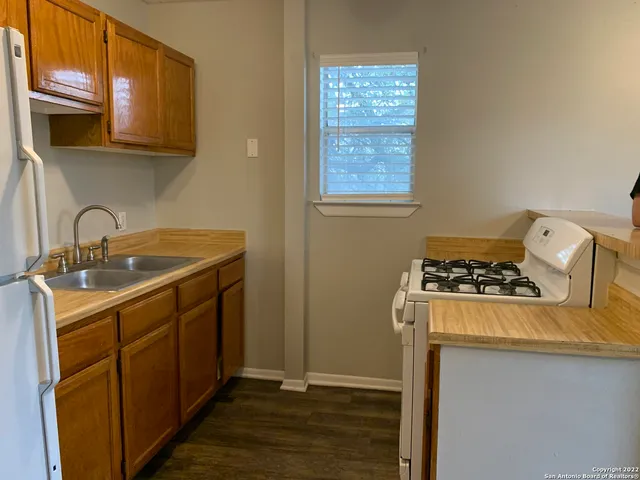 a kitchen with a sink stove and cabinets
