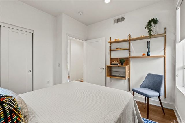 a bedroom with a bed and a chair in it