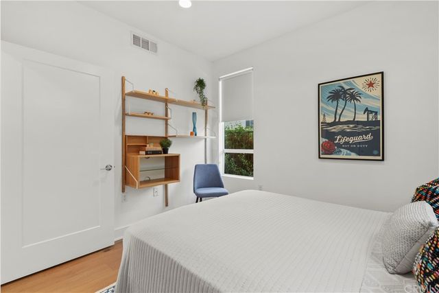 a bedroom with a bed and a view of kitchen