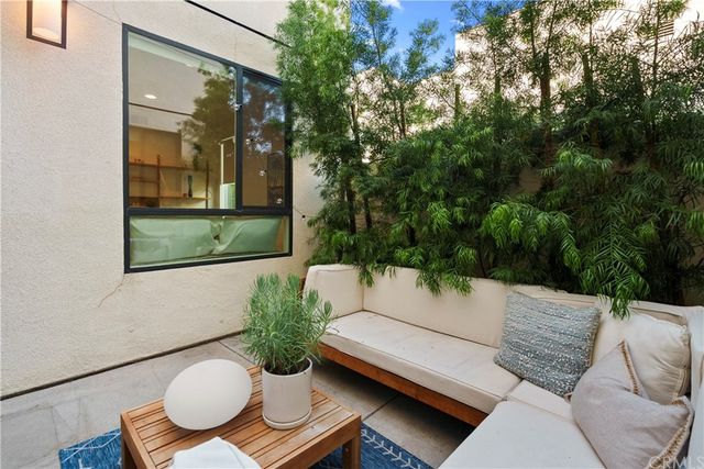 a outdoor living space with furniture and a potted plant
