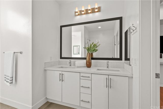 a bathroom with a double vanity sink and mirror