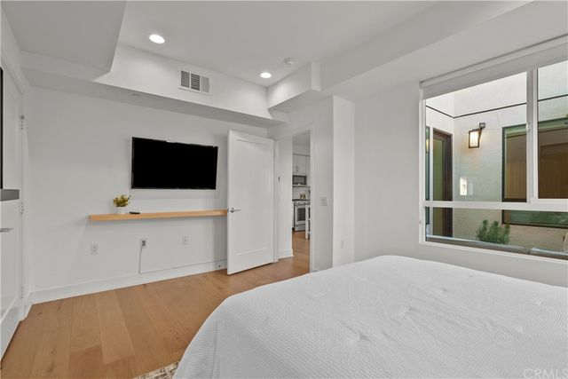 a bedroom with a bed and a flat screen tv