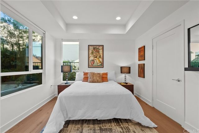 a bedroom with a large bed and a large window