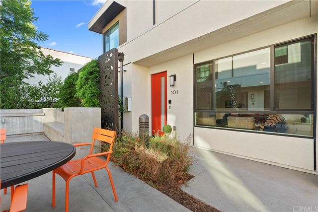a view of a patio with table and chairs and potted plants
