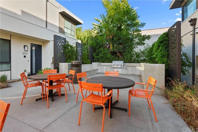 a backyard of a house with a table and chairs