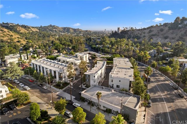a view of a patio with couches table and chairs and potted plants