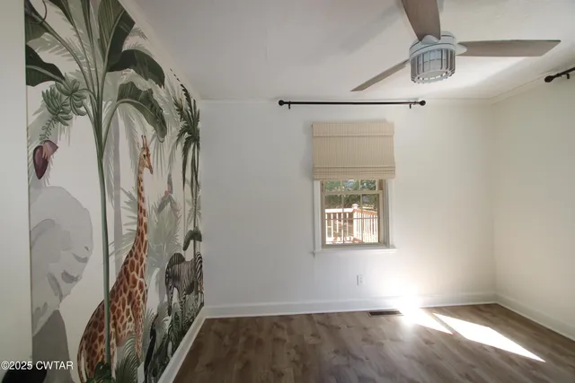 a view of a closet with wooden floor and a window