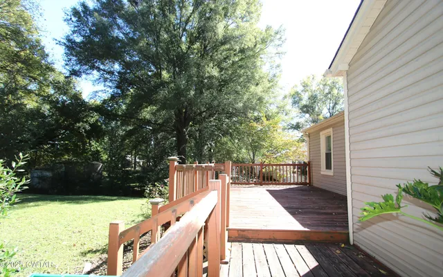 a view of balcony with wooden floor and fence