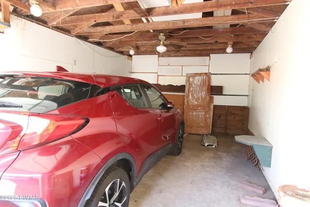 a front view of house with yard and trees around