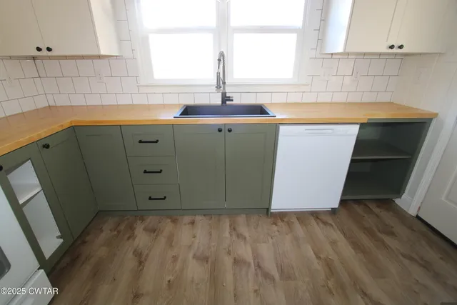a kitchen with sink cabinets and window