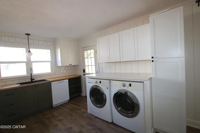 a utility room with sink dryer and washer