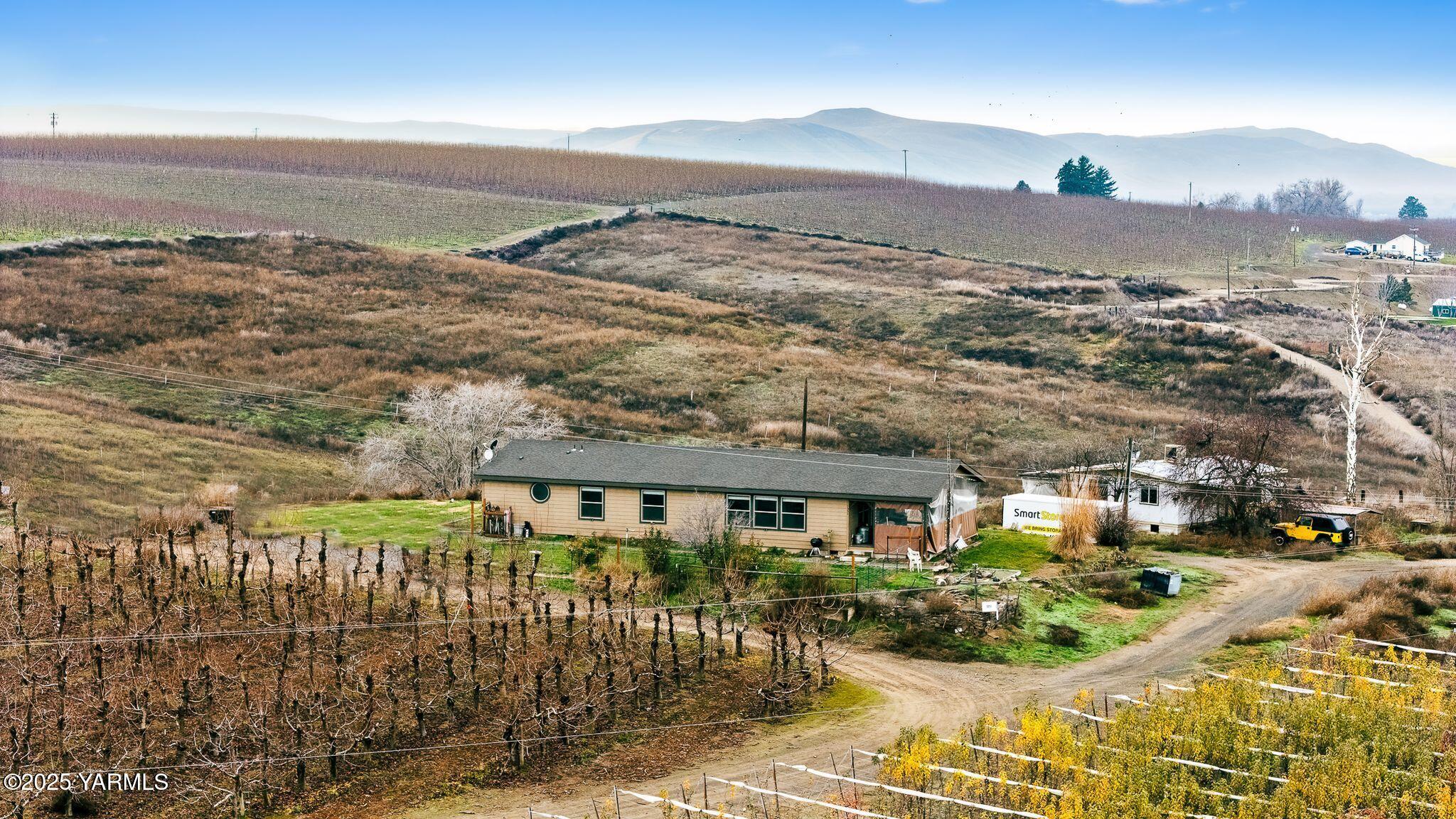 1351 Nass Road Granger, WA 98932 - Photo 1 of 38 a view of a city with tall buildings