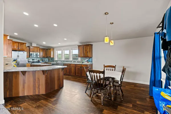 a kitchen with stainless steel appliances granite countertop a sink a stove and a refrigerator