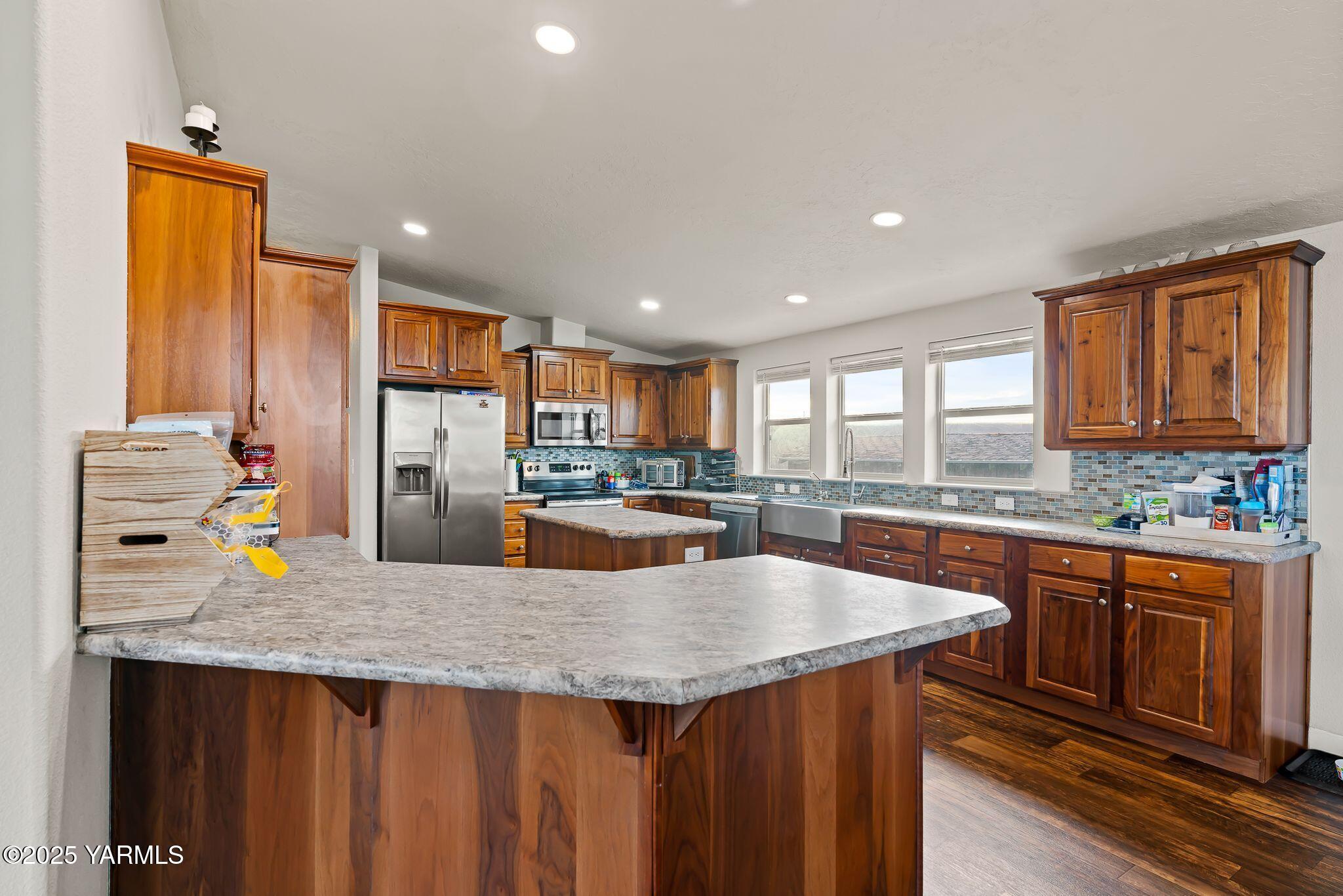 1351 Nass Road Granger, WA 98932 - Photo 13 of 38 a kitchen with stainless steel appliances granite countertop a sink a stove and a refrigerator