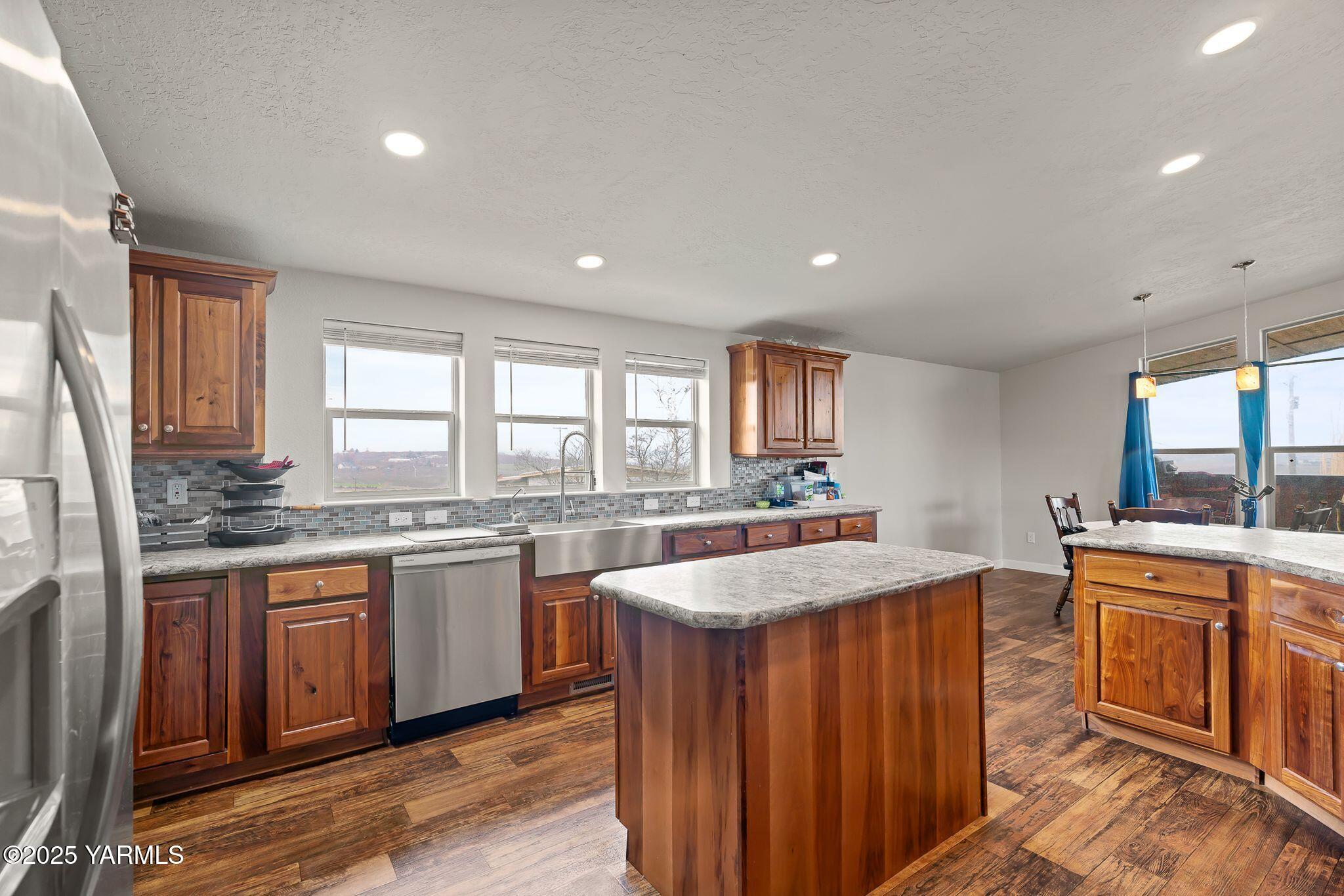 1351 Nass Road Granger, WA 98932 - Photo 14 of 38 a large kitchen with granite countertop a sink and cabinets with wooden floor