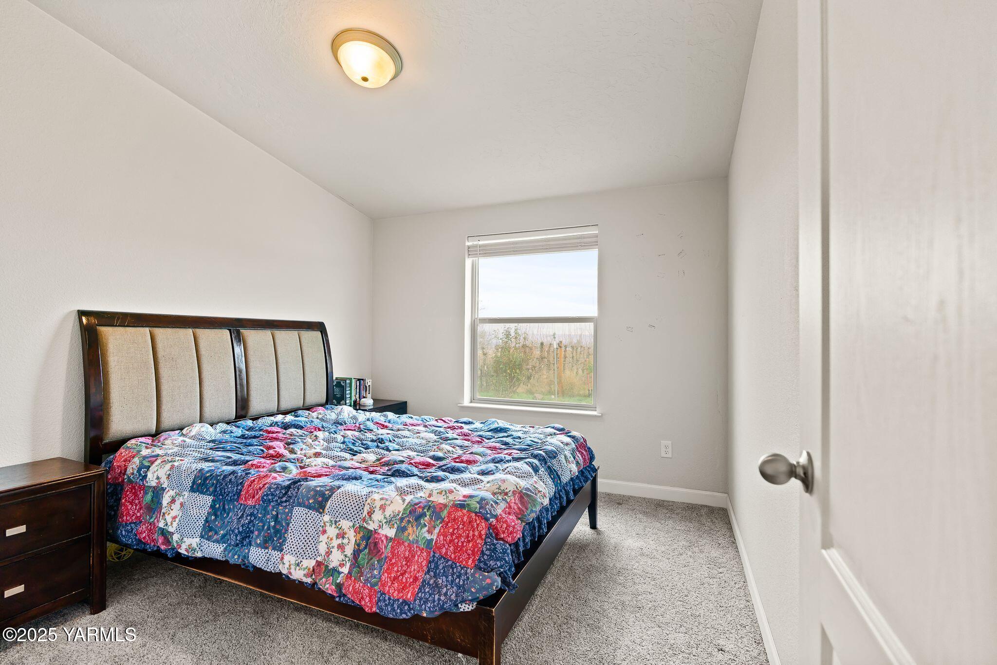 1351 Nass Road Granger, WA 98932 - Photo 17 of 38 a bedroom with a bed and a window