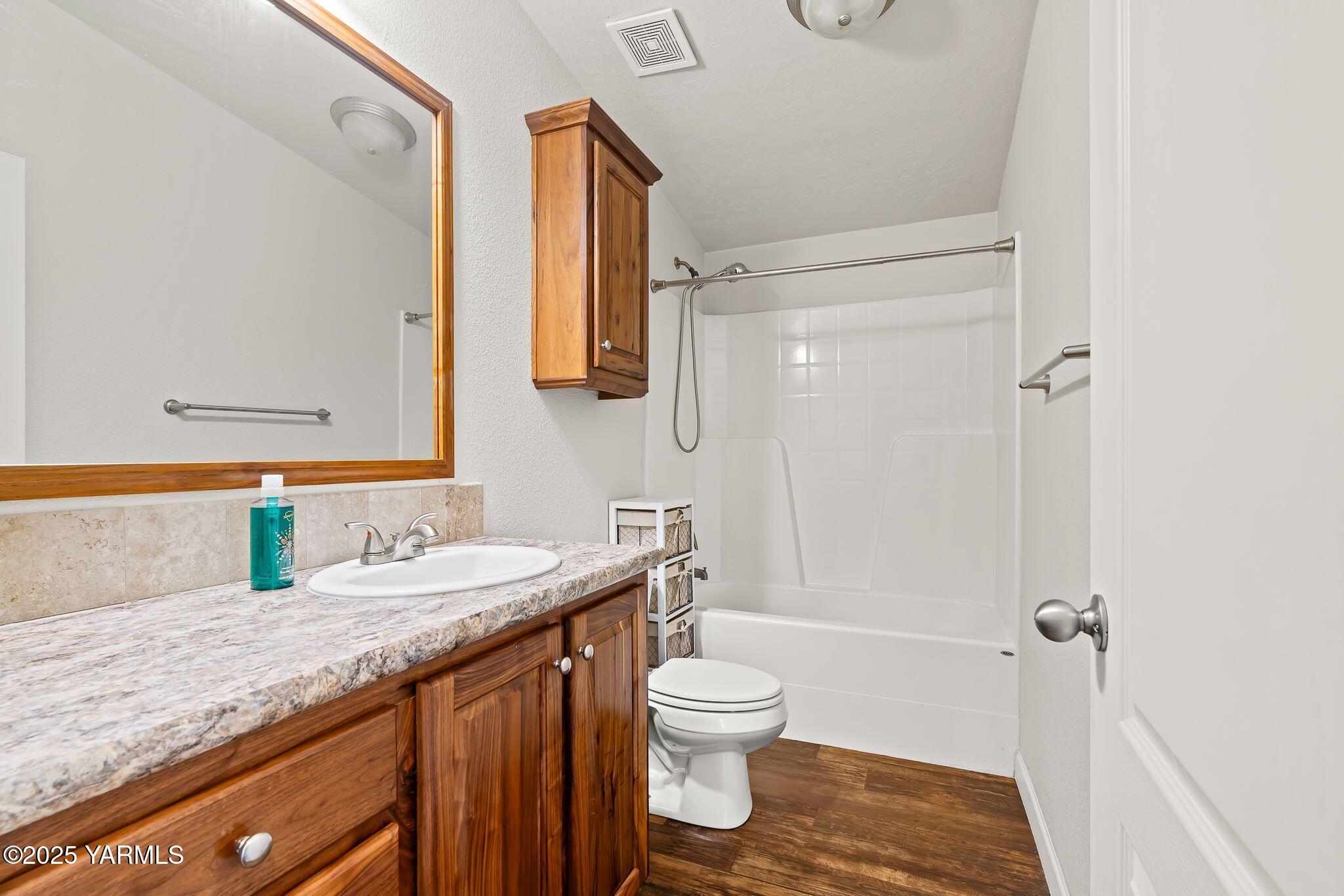 1351 Nass Road Granger, WA 98932 - Photo 19 of 38 a bathroom with a granite countertop sink toilet and shower