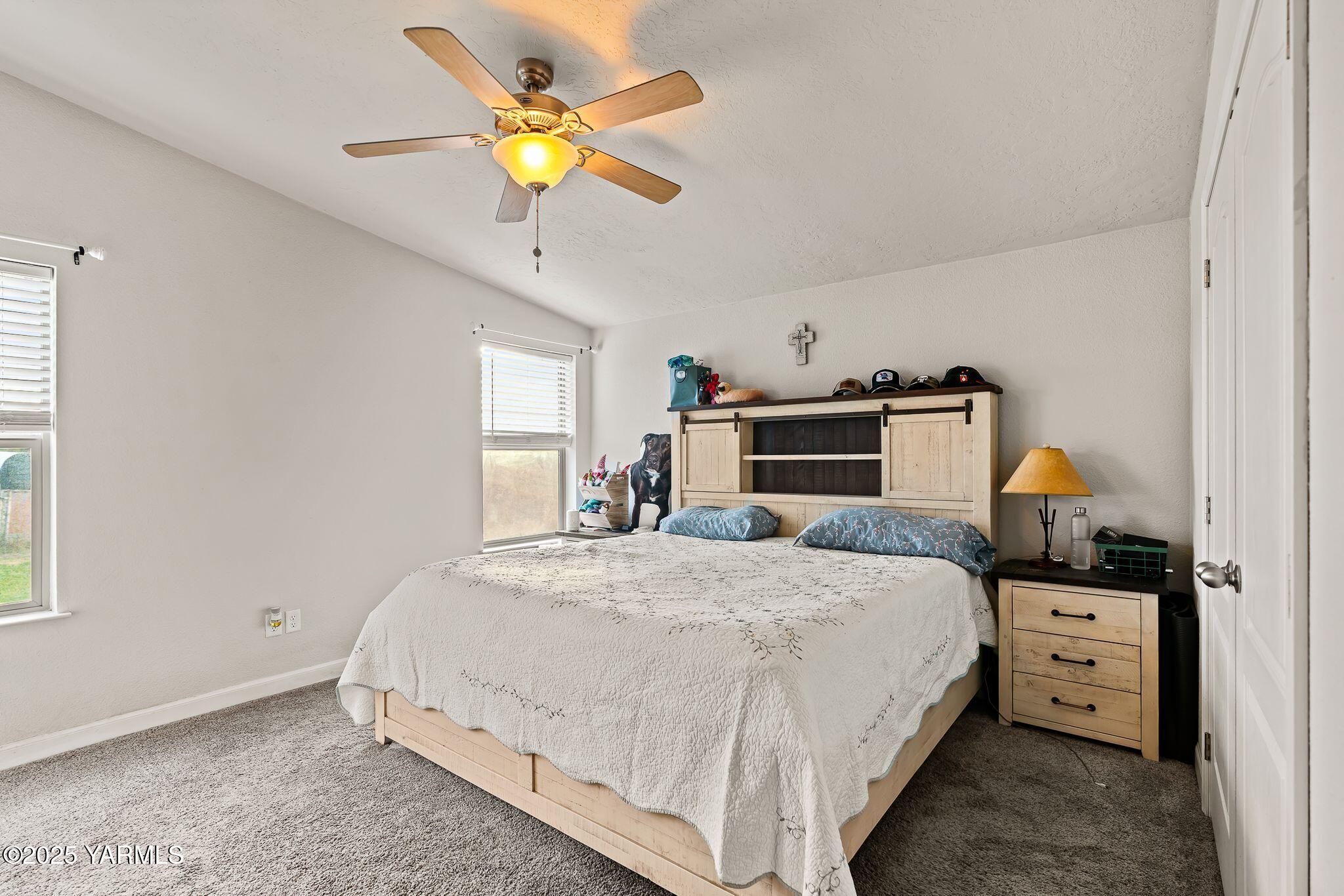 1351 Nass Road Granger, WA 98932 - Photo 20 of 38 a bedroom with a bed and a chandelier