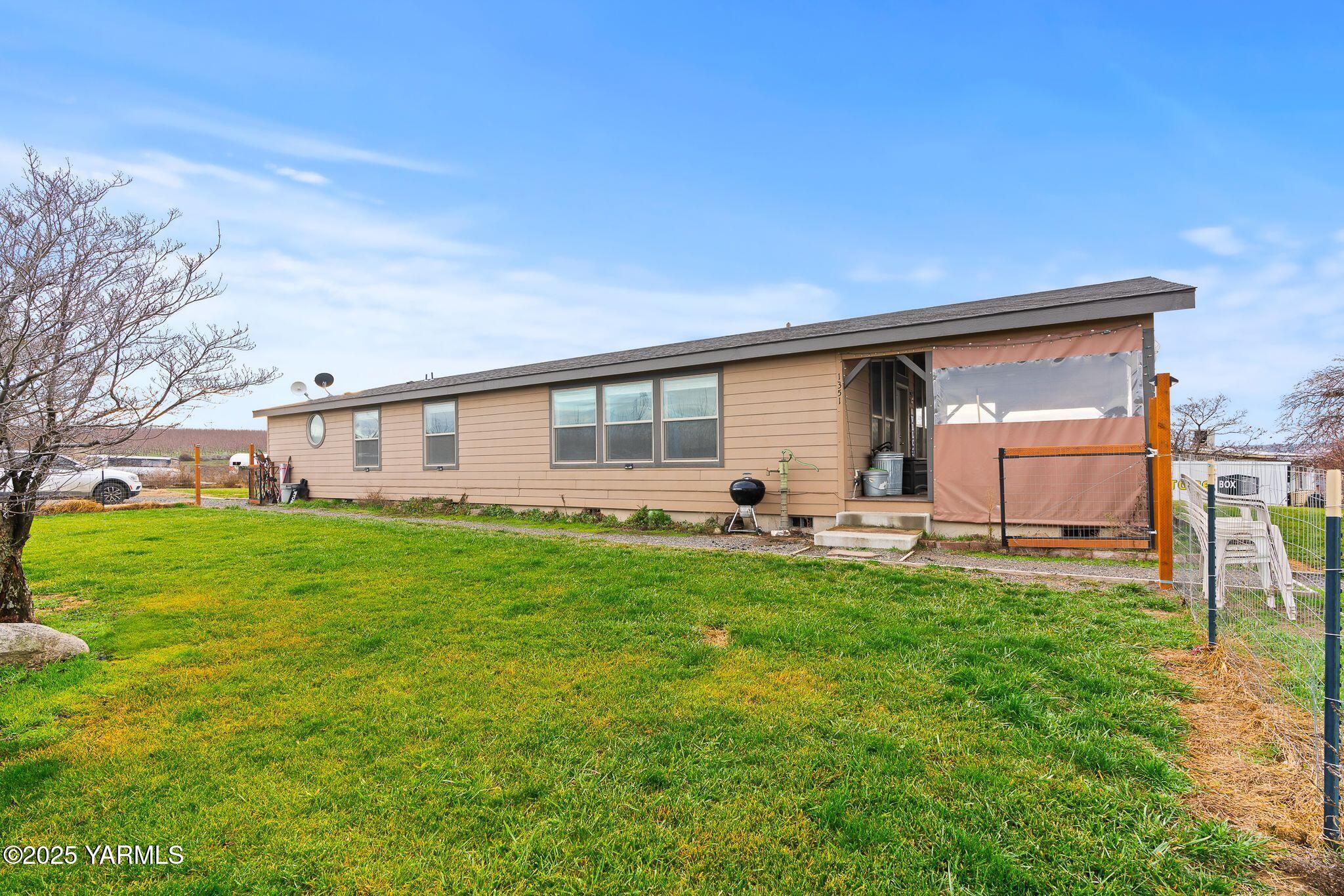1351 Nass Road Granger, WA 98932 - Photo 2 of 38 a backyard of a house with table and chairs