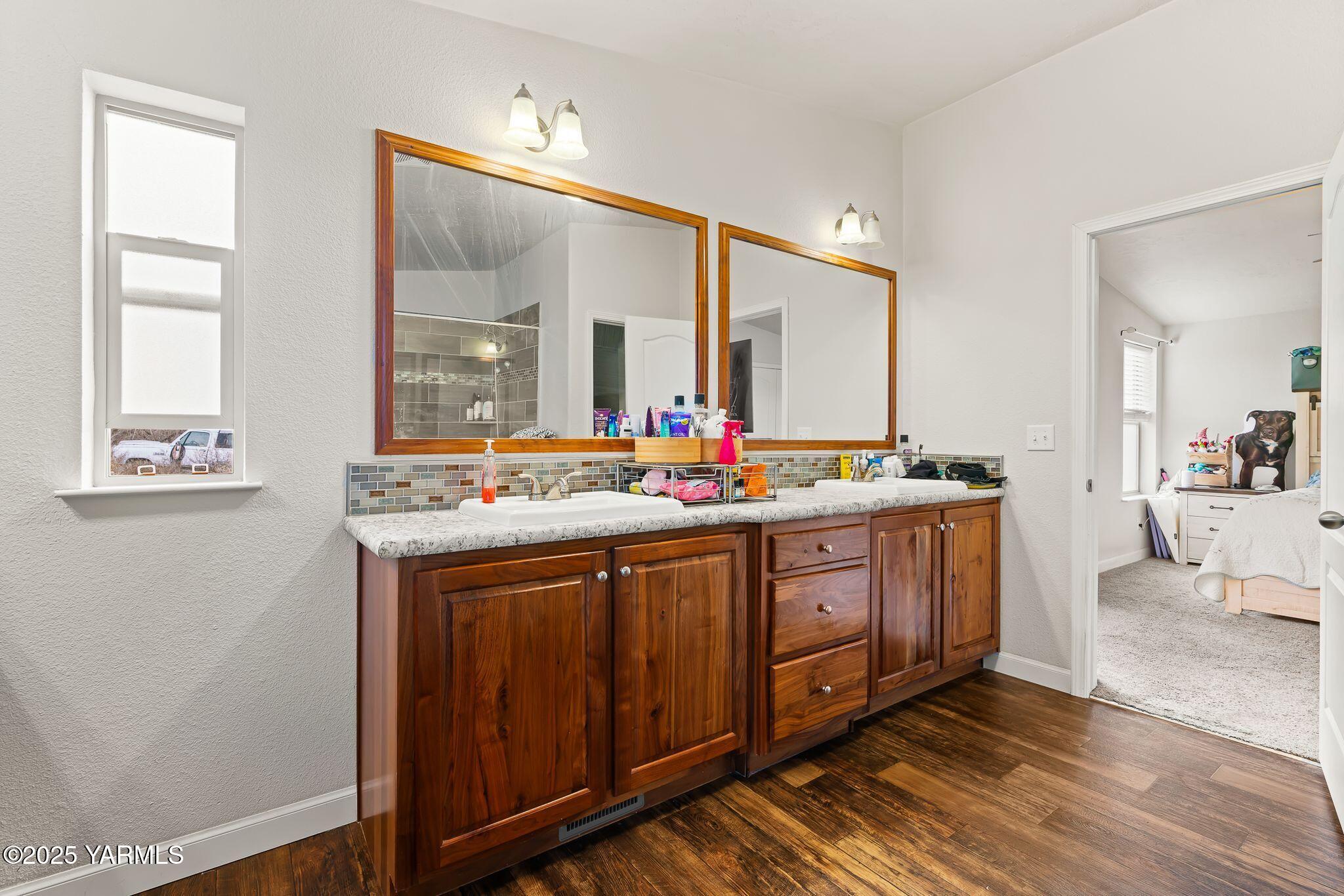 1351 Nass Road Granger, WA 98932 - Photo 22 of 38 a spacious bathroom with a double vanity sink and a mirror