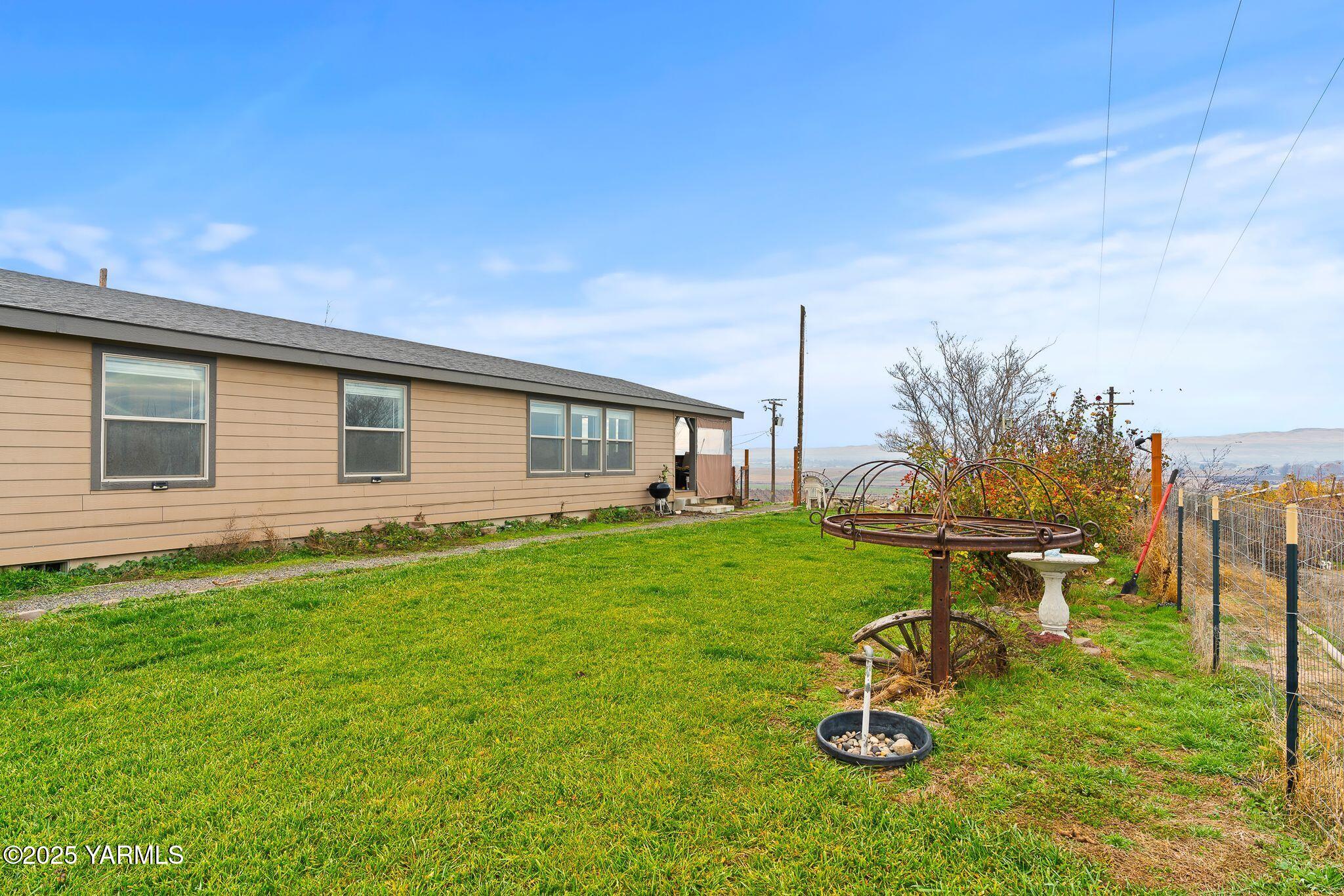 1351 Nass Road Granger, WA 98932 - Photo 4 of 38 a view of a backyard with couches plants and large trees