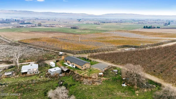 a view of a balcony with chairs and wooden floor
