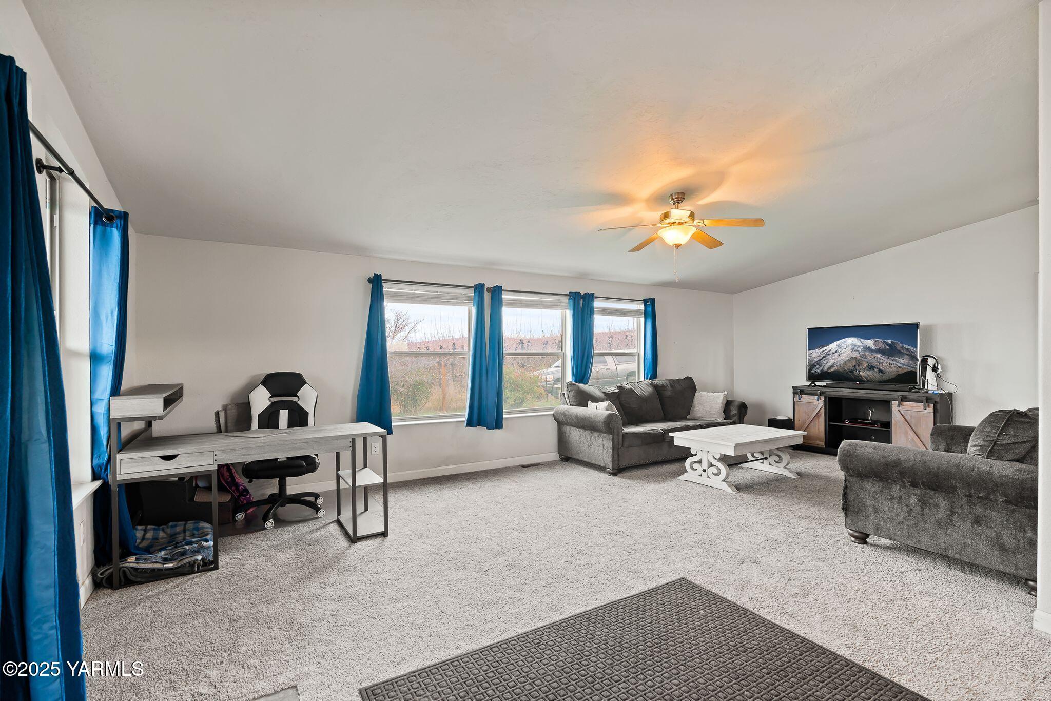 1351 Nass Road Granger, WA 98932 - Photo 8 of 38 a living room with furniture and a flat screen tv