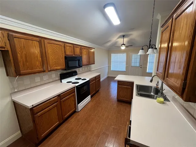 a kitchen with stainless steel appliances a stove a sink and a microwave