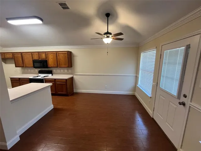 a view of kitchen and microwave with wooden floor