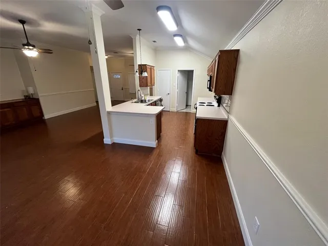 a view of kitchen with sink and wooden floor