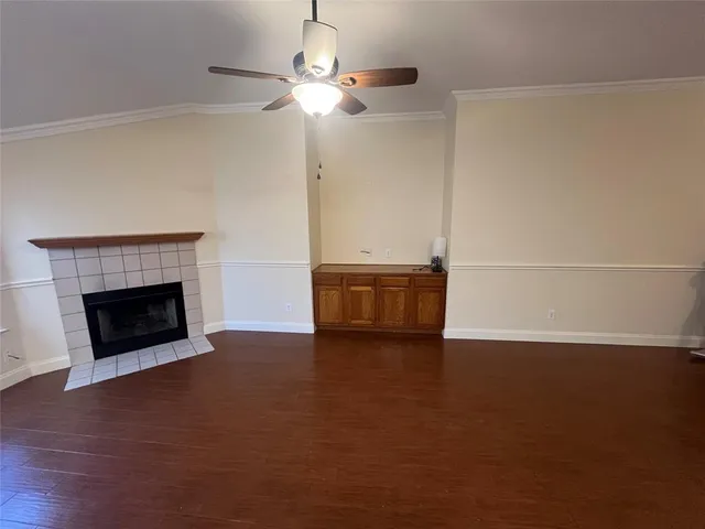 a view of a room with wooden floor and fireplace