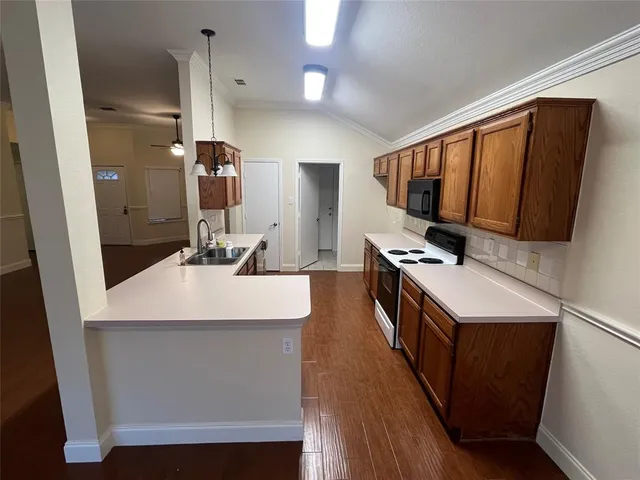 a kitchen with a sink appliances and cabinets