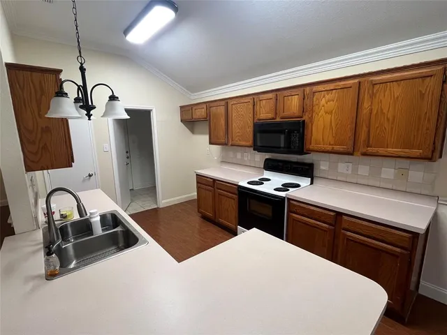 a kitchen with stainless steel appliances a stove sink and microwave