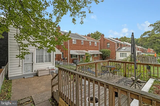 a view of a house with a small yard and wooden fence