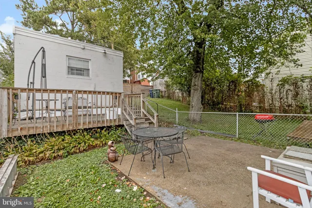 a view of a chair and table in the backyard