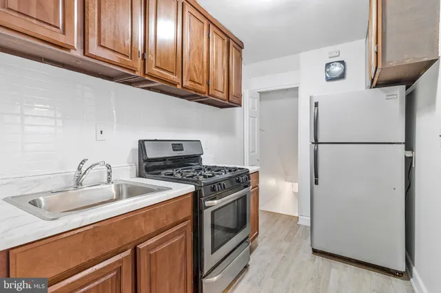 a kitchen with a refrigerator stove and sink