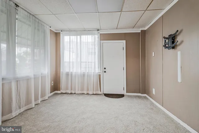 a view of a room with a chandelier fan and closet area