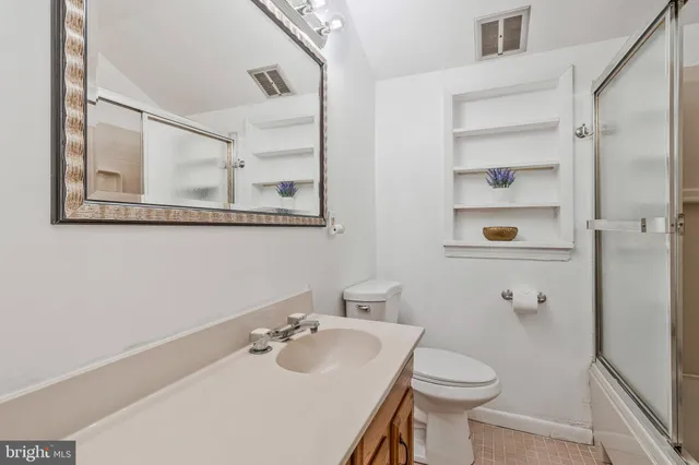a bathroom with a sink toilet and vanity