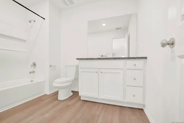 a bathroom with a toilet a sink and bathtub
