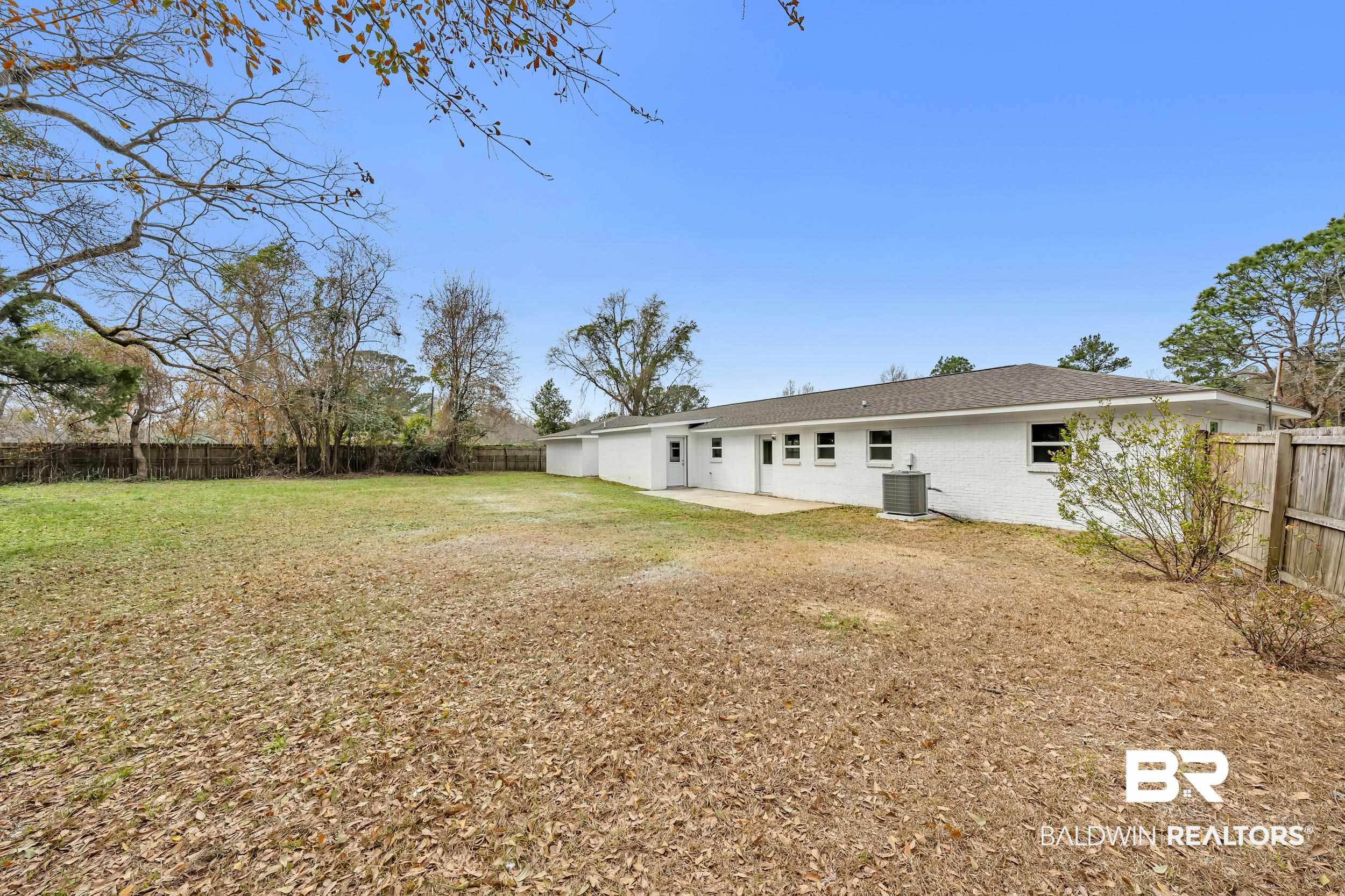 11381 Normandy Drive East Semmes, AL 36575 - Photo 21 of 23 Rear view of property with a patio area, a fenced backyard, and brick siding