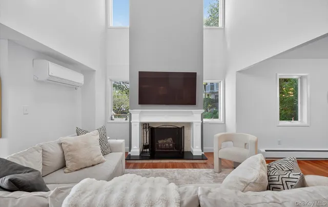 a living room with furniture a fireplace and a flat screen tv