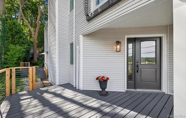 a view of a deck with wooden floor and a potted plant