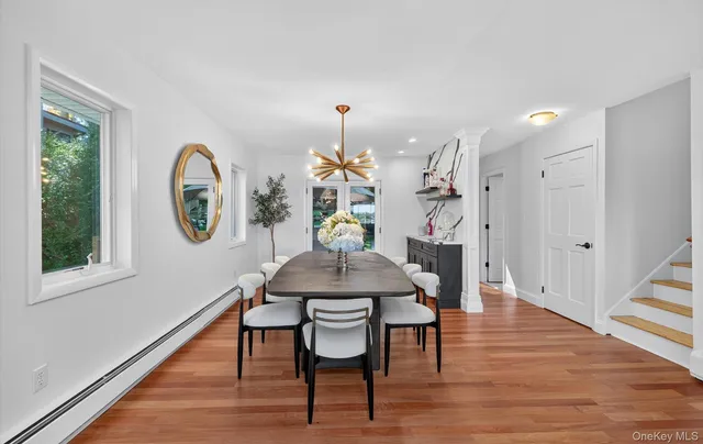 a view of a dining room with furniture window and wooden floor