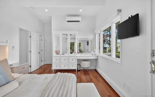 a room with a bed and a flat screen tv